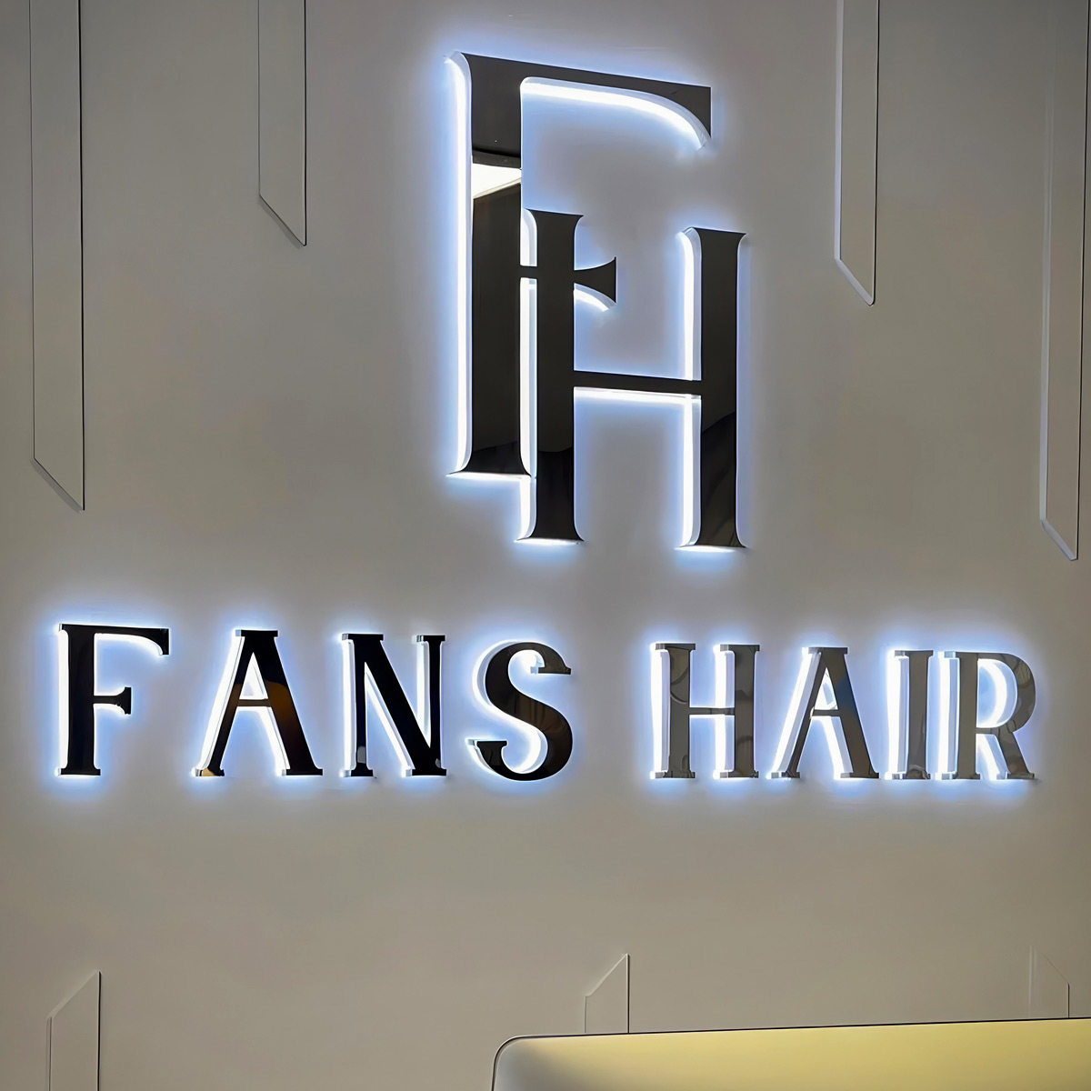 Custom 3D halo lit signage in Dubai with illuminated stainless steel letters for hair salon