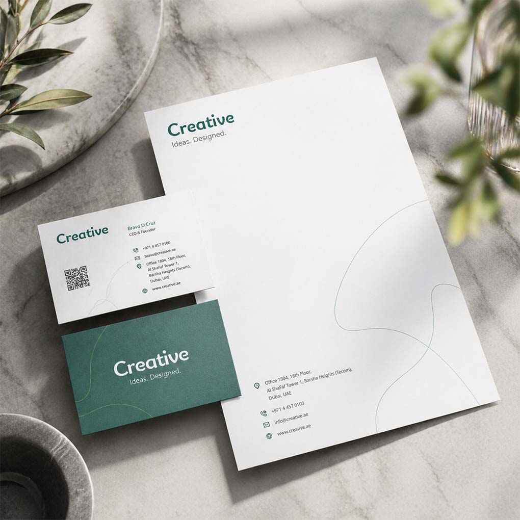 Custom branded letterhead with green and white business cards featuring a QR code