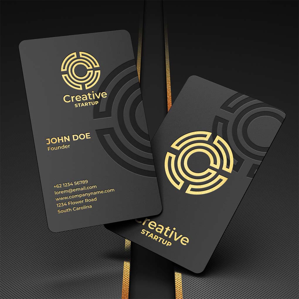 Luxury black business cards with gold logo and embossed geometric design
