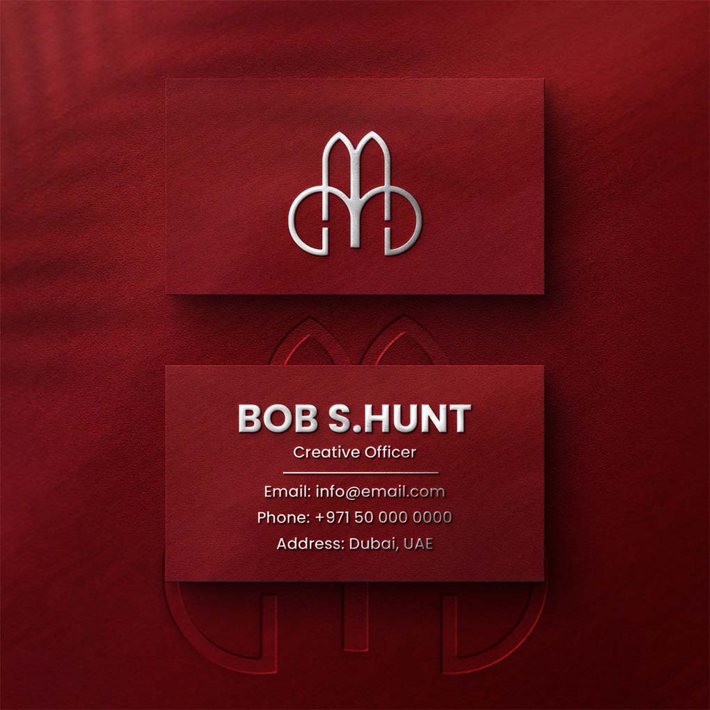 Premium red business card with raised silver logo and contact details