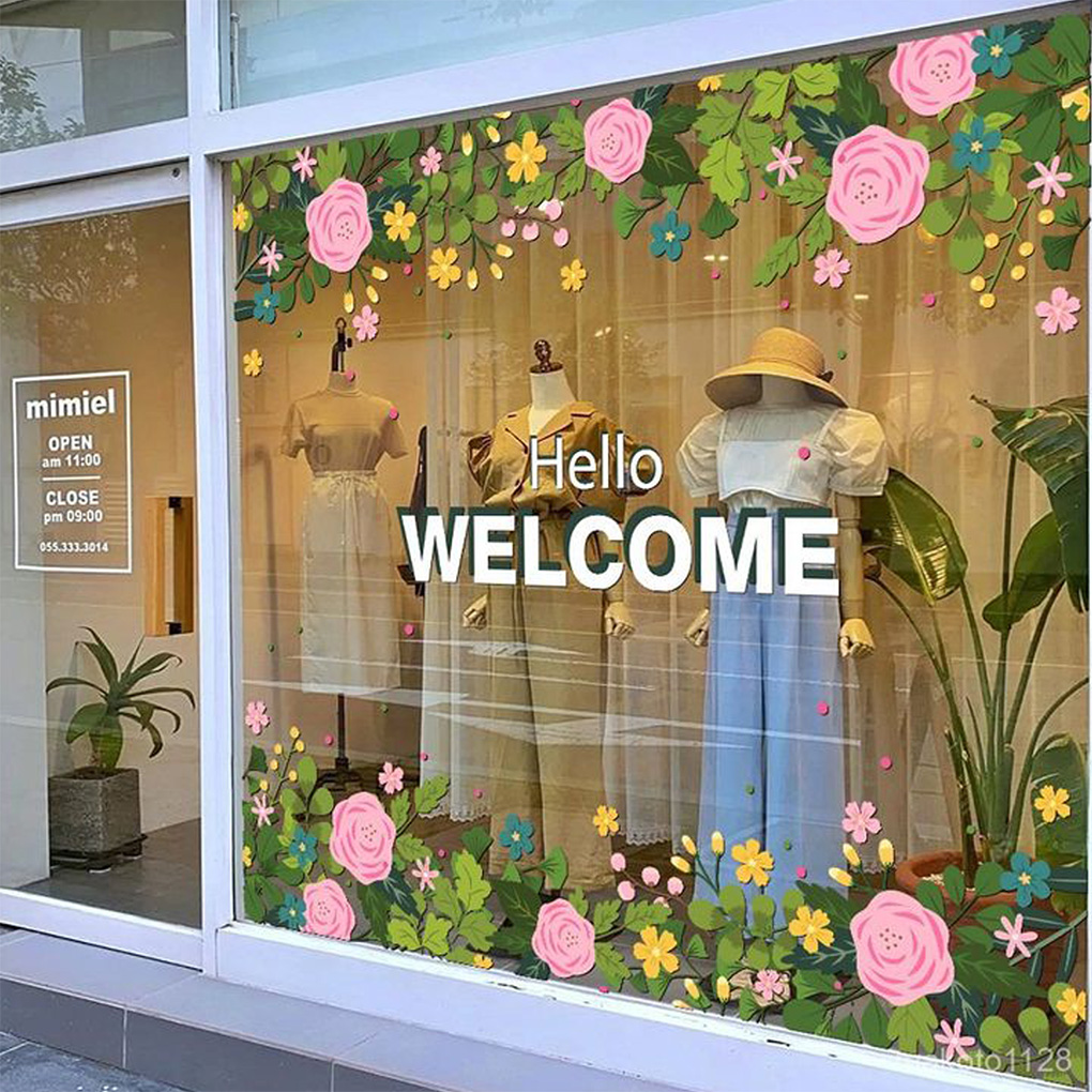Decorative floral vinyl stickers and welcome graphics for retail storefront glass windows in Dubai
