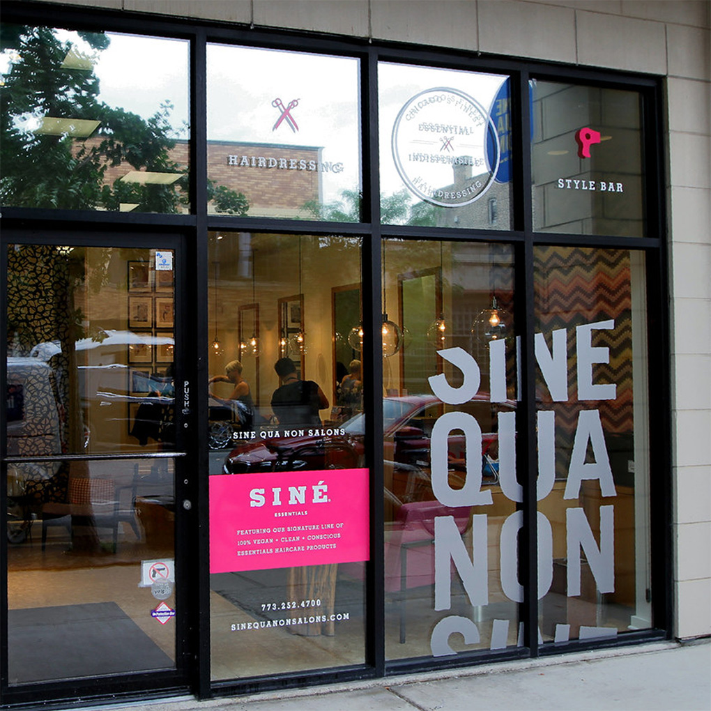 Custom vinyl cut lettering, logo and promotional graphics for salon glass storefront signage in Dubai